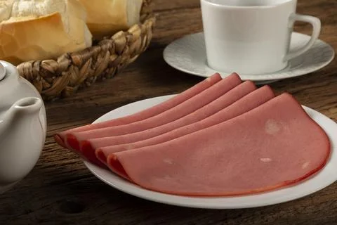 Sliced ??mortadella with breads on the table. Stock Photos