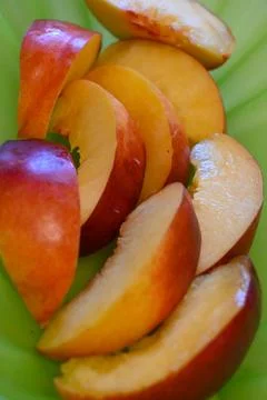 Sliced nectarine on a green background 스톡 사진