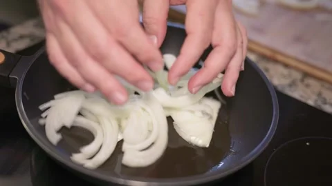 Sliced onion cooking in a pan with hot oil Stock Footage 335869826