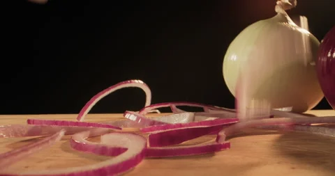 Sliced onion falling on a cutting board. The process of cooking a meal. Making Stock Footage 293507211