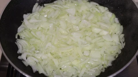 Sliced onion in a frying pan Stock Footage 129058591