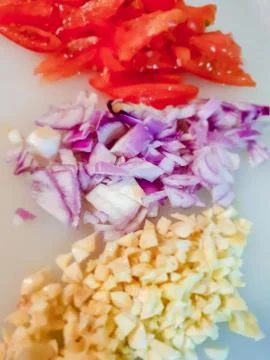 Sliced onion, garlic, and tomato Stock Photos