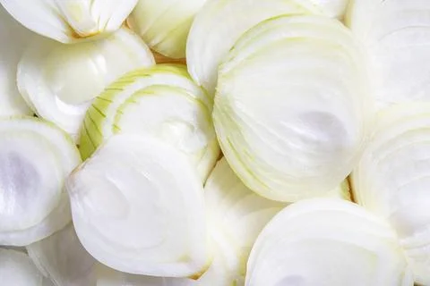 Sliced onion on the table. Vegetables in the kitchen prepared to serve. Stock Photos