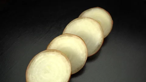 Sliced onions on a black background close-up. Stock Footage 147721725