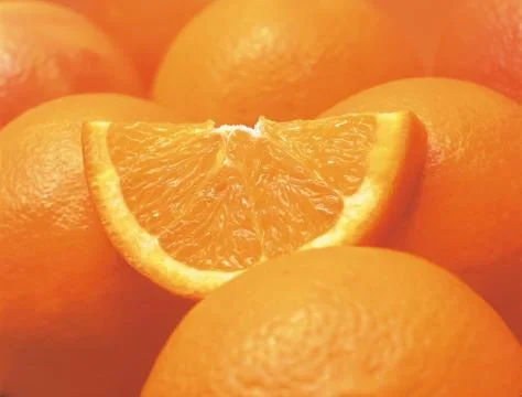 Sliced orange and whole oranges Stock Photos