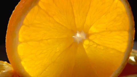 Sliced orange closeup on a black background Видео 134532281
