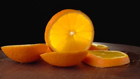Sliced orange closeup on a black background 스톡 동영상 134532466