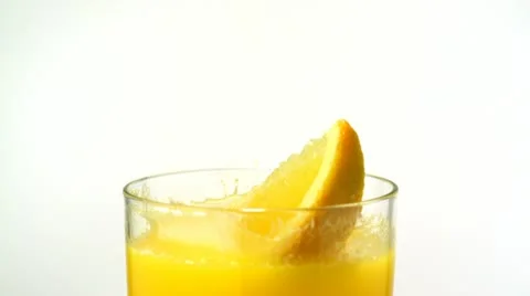 Sliced orange falling into orange juice, Slow Motion Stock Footage 18155335