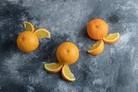 Sliced orange fruit on a marble background Stock Photos