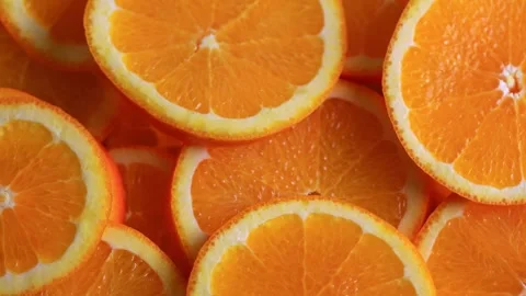 Sliced orange fruit rotation, close up 4k Stock Footage 327963687