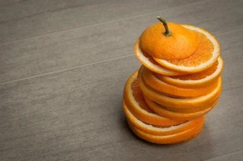 Sliced orange on gray background Stock Photos