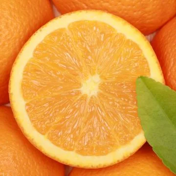 Sliced orange with a leaf Stock Photos