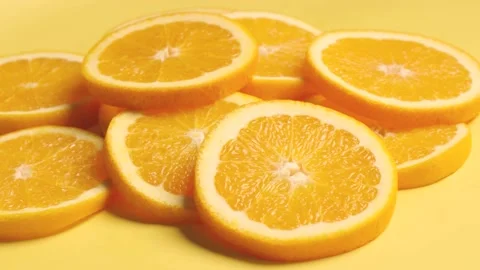Sliced orange on orange background, turn shot Stock Footage 233948748