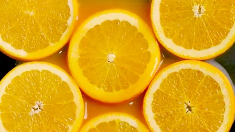 Sliced orange stack into orange juice shooting with slowmotion Stock Footage 233948695