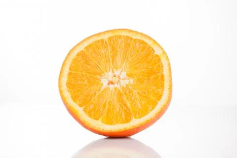 Sliced ??orange on a white background with reflection at the bottom. Isolated Stock Photos