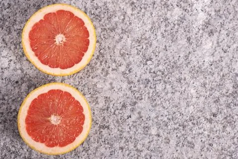 Sliced oranges on a background of solid granite. Stock Photos