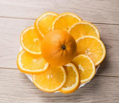 Sliced oranges isolated on wooden table background Stock Photos