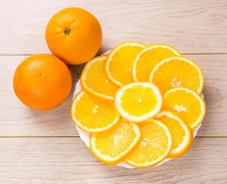 Sliced oranges isolated on wooden table background Stock Photos