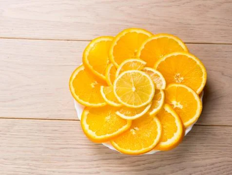 Sliced oranges isolated on wooden table background Stock Photos