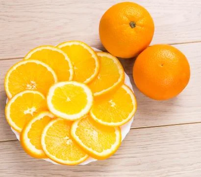 Sliced oranges isolated on wooden table background Stock Photos