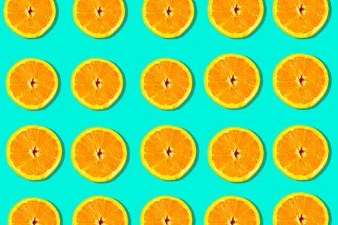 Sliced oranges pattern on green  background, minimal concept Stock Photos