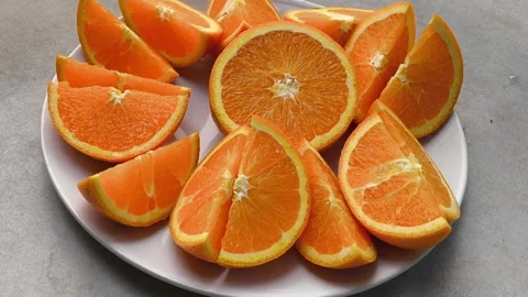 Sliced oranges placed on a white plate Stock-Footage 292622093