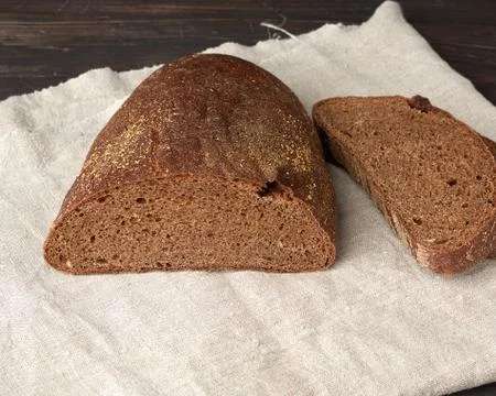 Sliced oval rye bread bread on a wooden board Stock Photos