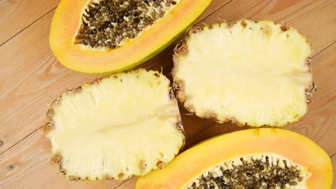 Sliced papaya and pineapple on the table. Stock Footage 238583734