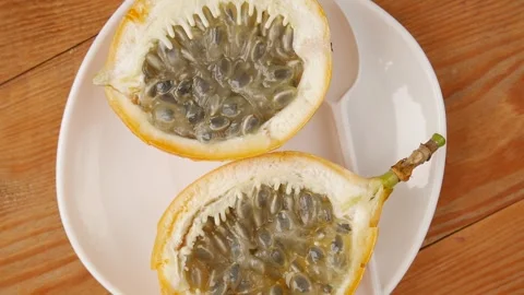 Sliced passion fruit on a plate. Stock Footage 243837529