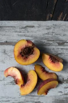Sliced peaches in rustic setting flat lay Stock Photos
