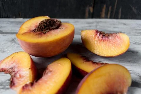Sliced peaches in rustic setting Stock Photos