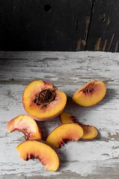 Sliced peaches in rustic setting Stock Photos