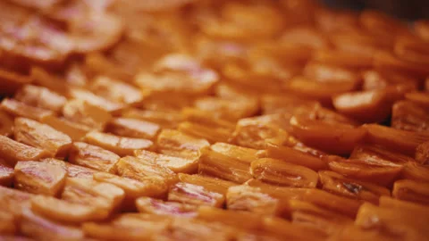 Sliced persimmons drying on a rack for preservation. rack focus Stock Footage 332122170