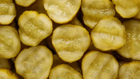 Sliced pickles cucumbers top view, rotating. Waves chopped cucumbers Stock Footage 224095823