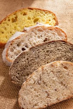 Sliced pieces of different bread on a burlap close-up Stock Photos