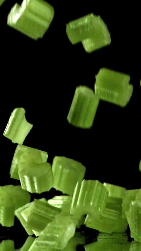 Sliced pieces of fresh celery fall on the table. Filmed on a high-speed camera Stock Footage 335365086