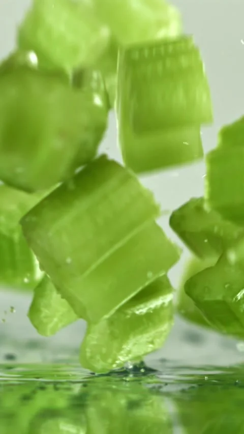 Sliced pieces of fresh celery fall on the table. Filmed on a high-speed camera Stock Footage 335368849