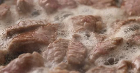 Sliced pieces of meat are fried in a frying pan. Stock Footage 250020039