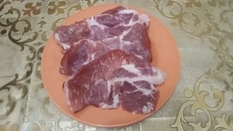 Sliced ​​pieces of meat lie on a plate Stock Footage 227295576