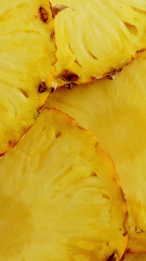 Sliced pieces of pineapple fruit. rotating Stock Footage 307245732