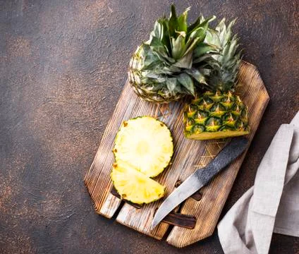 Sliced pineapple on cutting board Stock Photos