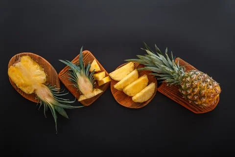 Sliced pineapple in different shapes. Ripe pineapple on cutting board cooking Stock Photos