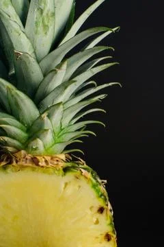 Sliced pineapple fruit close up, black background Foto stock
