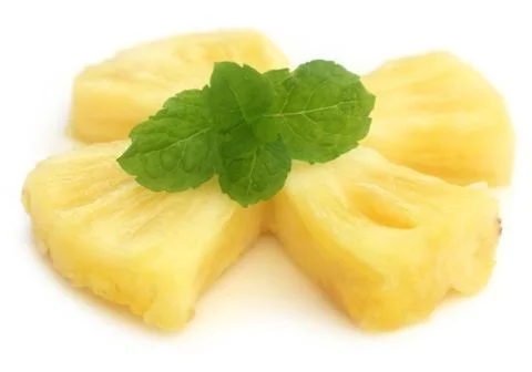 Sliced pineapple with mint leaves Stock Photos