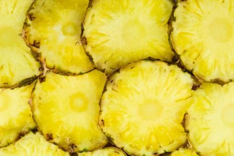 Sliced pineapple pieces lay in pattern, top view Stock Photos