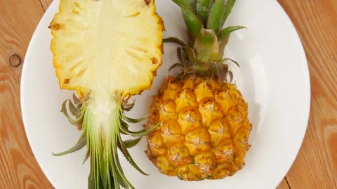 Sliced pineapple on a plate. 스톡 동영상 239713414