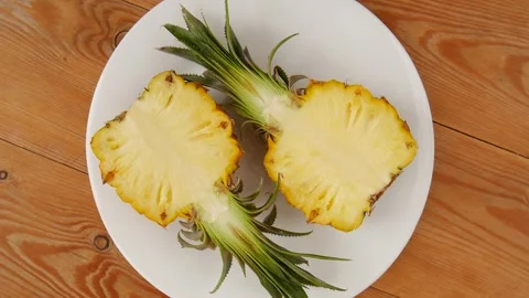 Sliced pineapple on a plate. Video stock 248035790