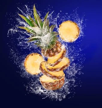 Sliced Pineapple in water splashes Stock Photos