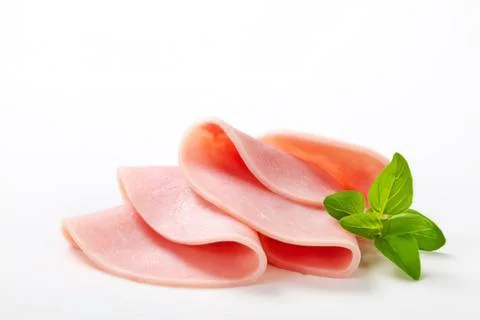 Sliced pink ham with fresh mint leaf Stock Photos