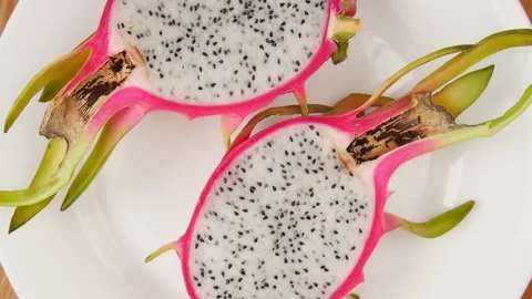 Sliced pitahaya on a plate. Video stock 245681611